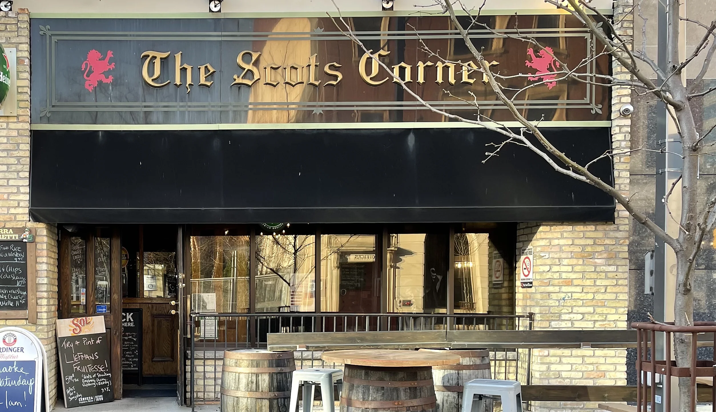 Entrance, sign and barrel tables of The Scot's Corner patio on Dundas Street